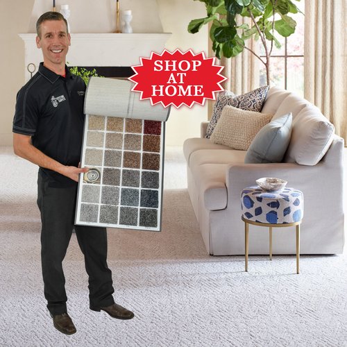 White carpet floor with man holding carpet samples - Keystone Carpets Inc in WA